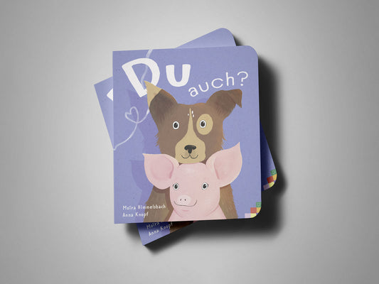 Ein veganes Pappbuch mit dem Titel Du auch? zeigt eine Illustration eines Hundes und eines Schweins auf lila Hintergrund.